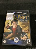 Closed game case of Harry Potter and the Chamber of Secrets for Nintendo GameCube showing the front cover art.