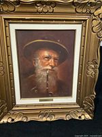 Frontal photo of original oil painting of elderly bearded man with pipe by Georg Kuboth in ornate gold frame.