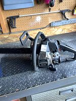 View of the entire Poulan Titanium 2550T chainsaw showing the 18-inch bar and handles.