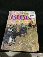 Front cover of The Children's Bible hardcover book showing illustrated biblical scene of people walking with animals and armed figures.