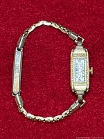 Full view of the Bulova ladies wristwatch showing rectangular face, dial with Arabic numerals, and gold-filled linked band with engraved panel.