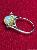 Side profile showing band thickness, prong settings and undergallery