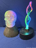 Both neon skull light and aqua-blue plasma lamp side by side showing their size, shape, and lighting effects.