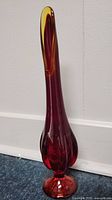 Full view of tall orange Viking slag glass vase showing bulbous base and elongated neck