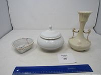 Photo showing Austria ceramic vase, covered dish, and ceramic basket together with a ruler for scale