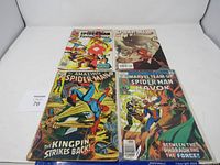 Four Spider-Man comic books laid out flat showing front covers.