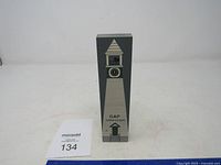 Full front view of a tall rectangular wooden decorative item representing a town clock tower with a cat figure and clock face graphic, marked GAP Town Clock.