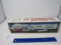 Original boxed 1992 Hess 18 Wheeler and Racer set viewed front showing truck, racer car, gas pump and background.