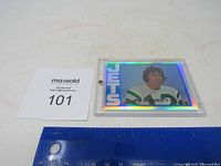Joe Namath New York Jets football card with holographic finish lying flat next to a measuring ruler and inventory tag