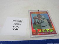 Full view of Joe Namath New York Jets football card in protective case with adjacent label showing lot number 92.