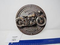 Metal round sign with detailed vintage motorcycle and 'Motorcycle Garage' text shown flat on white background with ruler for scale.