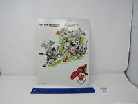 Full view of a vintage metal Texaco advertisement sign depicting dalmatian puppies around a barbecue grill and the Texaco star logo.