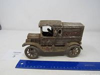 Side view of vintage Coca Cola metal delivery truck showing overall shape and condition