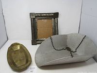 View of the metal scale basket, brass dish, and metal frame together