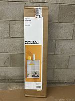 Full packaging box of the Room Essentials 3-shelf white wooden bookcase showing product image and branding.