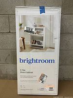Photo of the unopened box showing the Brightroom brand, product name, and image of the shoe cabinet in a home setting.