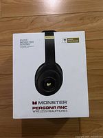Front of the sealed box showing the Monster Persona ANC wireless headphones packaging with branding and features.