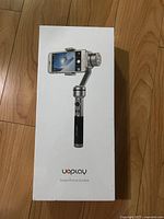 Image of the Uoplay smartphone gimbal stabilizer box showing the product image and branding on front of packaging.
