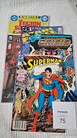 Four DC Comics including Legion of Super-Heroes Annual, Crisis on Infinite Earths, and Superman comics stacked showing front covers.