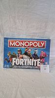 Front view of the sealed Fortnite Monopoly board game box featuring characters and branding.