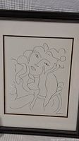 Front view of the framed Henri Matisse print showing detailed line art of a woman resting her head on her hand.