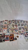 Full overview of all hockey cards and keyrings laid out on white fabric background.