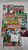 Three Marvel comics stacked showing covers with Avengers and Magik characters