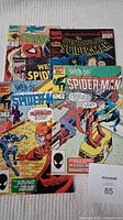Four Marvel comic books featuring Spider-Man: multiple issues from Web of Spider-Man and Spectacular Spider-Man series, showing covers with Spider-Man in action poses and some secondary characters.