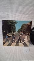Front cover of The Beatles Abbey Road LP record sleeve showing the famous Abbey Road crossing photograph.
