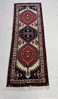 Full view of the rectangular Persian rug showing the overall pattern and colors laid flat.