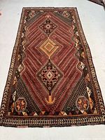 Full view of the Shiraz rug showing its full pattern and overall shape.
