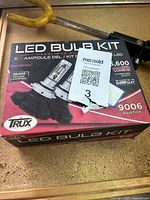 Photo of boxed Trux LED Bulb Kit labeled 9006 type showing package details about bulb lumen brightness and lifespan.
