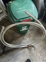 Full view of coiled BX electrical cable showing metal armored exterior