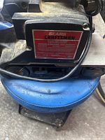 Close up of Craftsman label on blue electric belt sander showing model number 315.242290 and Sears branding.