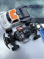 Losi micro truck with body, chassis, wheels, speed controller, and Spektrum receiver visible on top