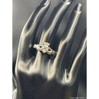 Ring on display hand showing full Claddagh design and stones