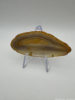 Front view of polished agate slice on stand
