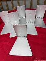 Front view of six identical small silver Umbra floating shelves