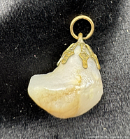 Front view of pearl nugget pendant showing gold-tone cap and bail