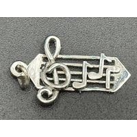 Front view of sterling silver music charm showing treble clef and notes