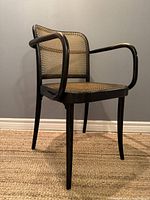 Front right three-quarter view showing the chair’s bentwood frame and cane weave
