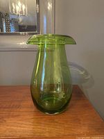 Front angled view of vintage IKEA green glass mushroom vase showing shape and color.