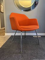 View of chair from front-left angle showing upholstery and chrome legs