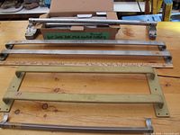 Crash door mechanism, metal push bars, and beige handle support arranged on wooden surface