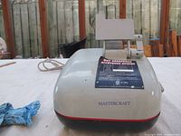 Front view showing Mastercraft branding, control label, and auto-feed mechanism on top