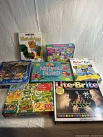 Full view of colorful children's games and puzzles showing packaging and titles.