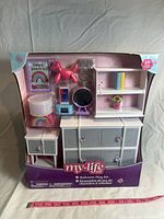 Front view of new unopened My Life As bedroom play set toy box showing contents of furniture and accessories inside.