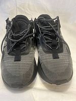 Front angled view of Nike Air Max 2021 triple black sneakers showing mesh upper and patterned laces.