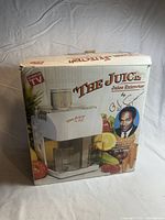 Original box for the O.J. The Juice electric juicer with product image, O.J. Simpson photo, and branding.