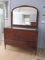 Front view of full dresser with attached mirror and glass top protector